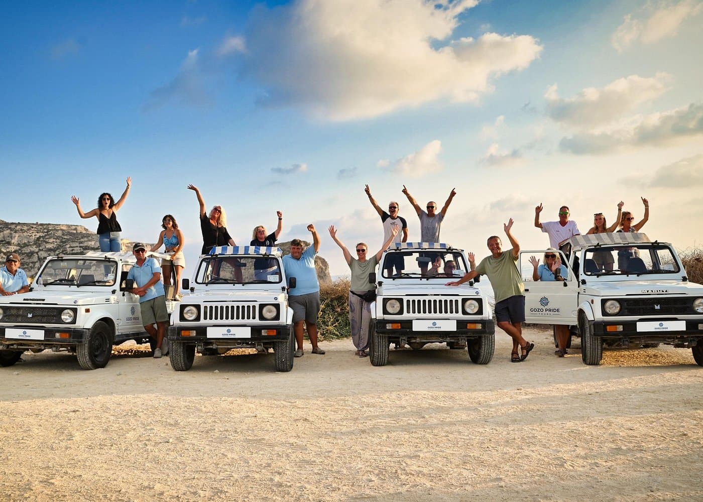 Pride jeep tour along a Gozo coastal road.