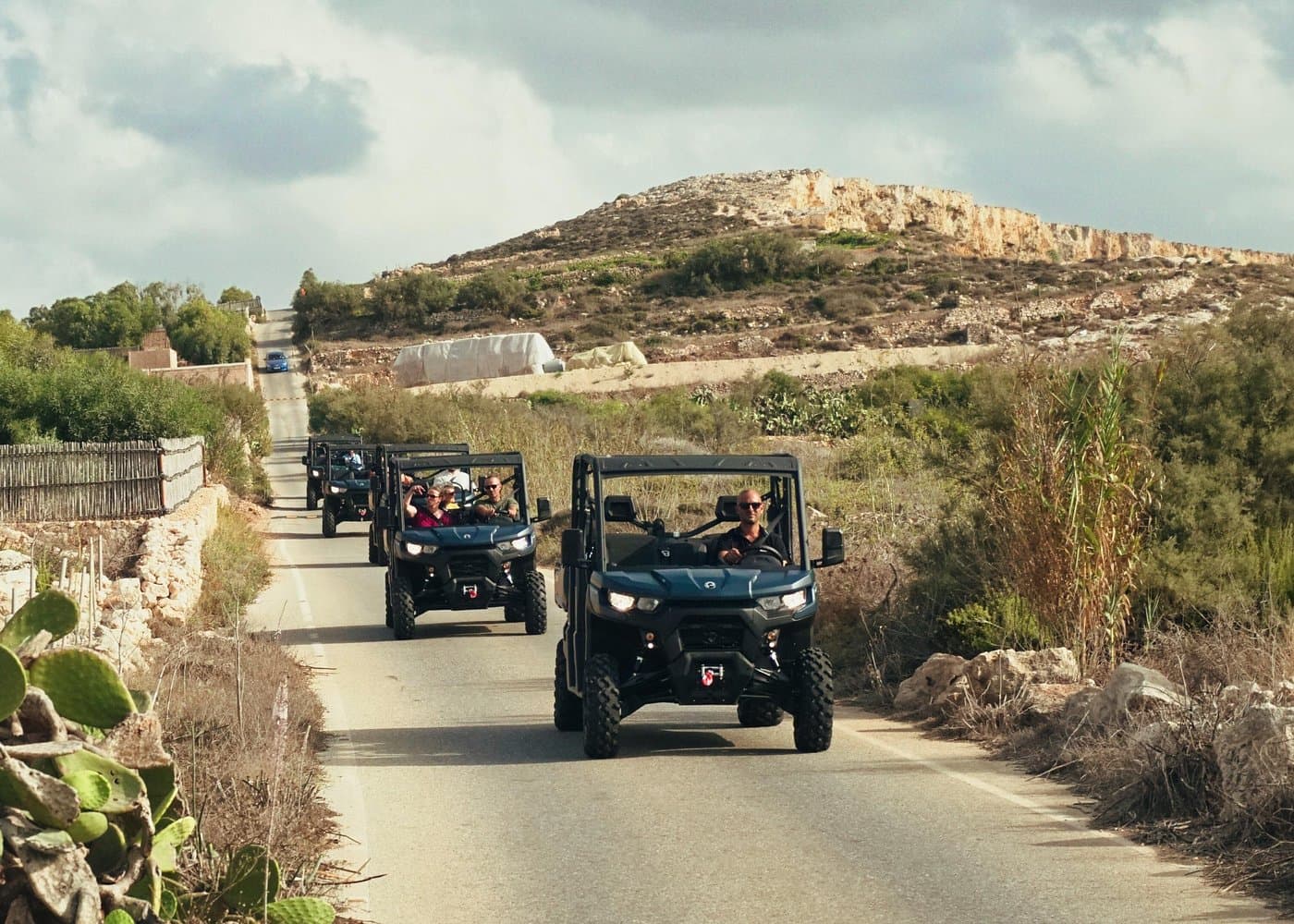 Six-seater UTVs on a Gozo country road during a full-day Pride tour.