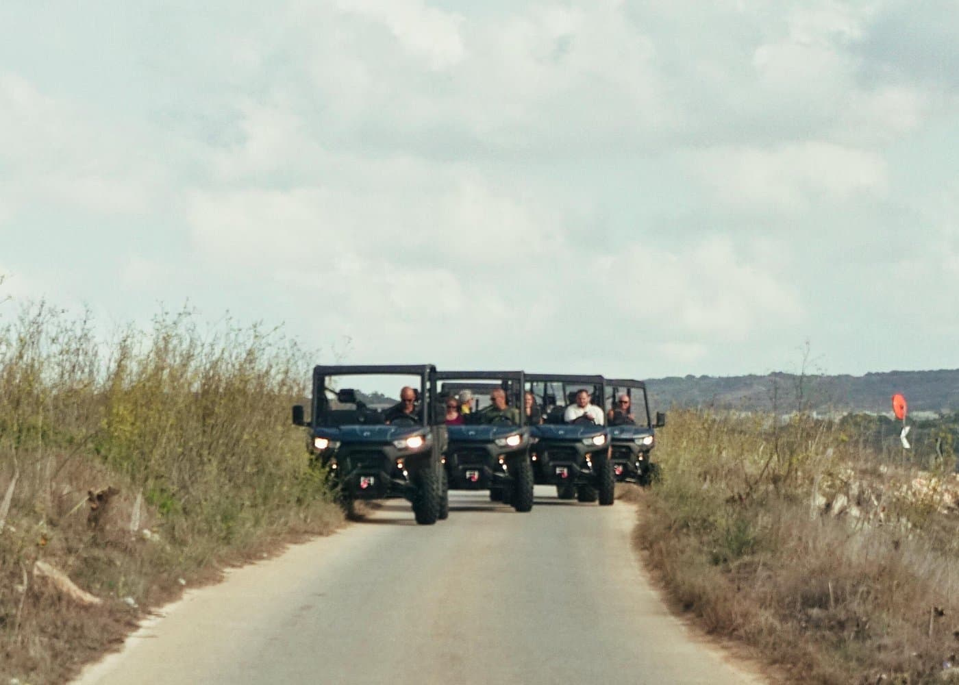 Passengers in a Gozo Pride 6-seater UTV.