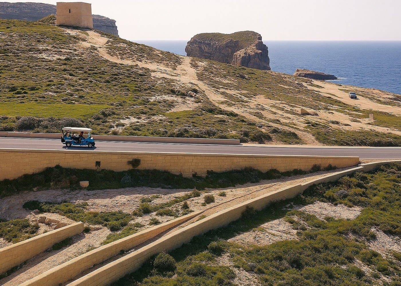 Golden-hour tuk tuk on a Gozo coastal road.