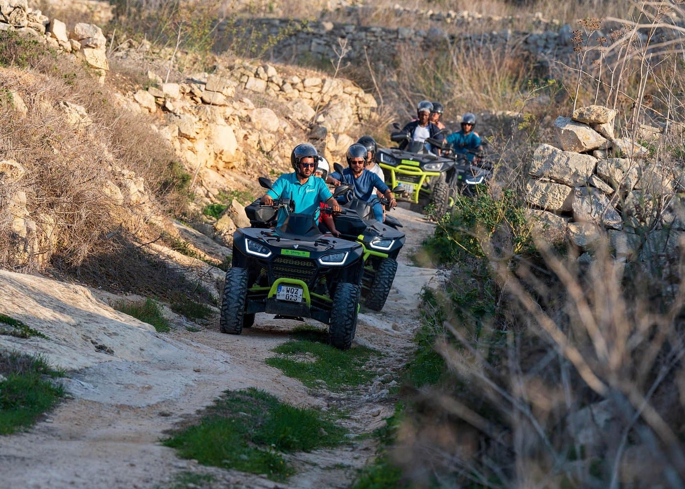 Gozo quad convoy with helmets on a dusty track.